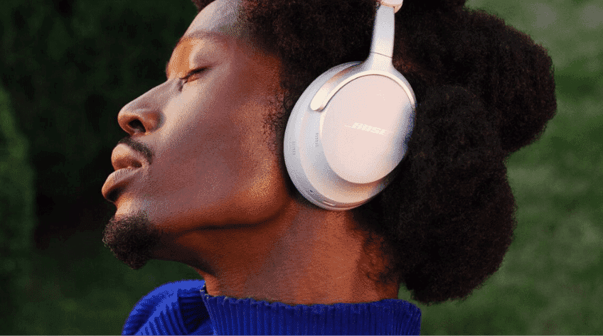 A man wearing white Bose Ultra Headphones