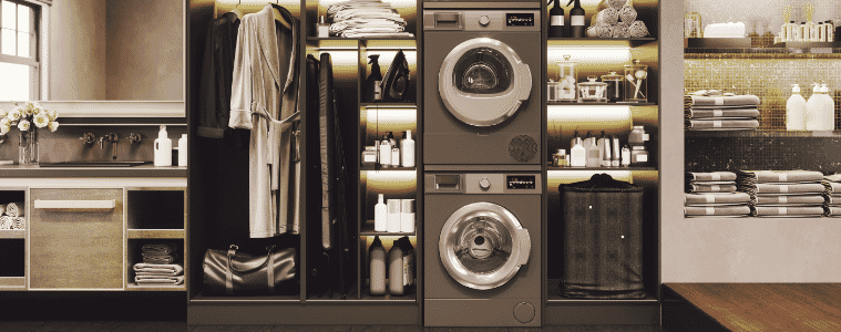 A black washer and dryer unit are stacked on top of each other in a luxurious bathroom