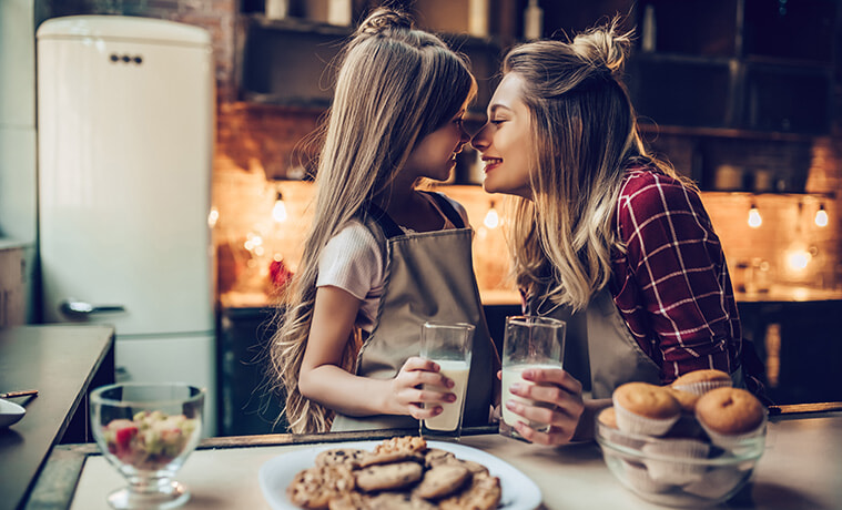 Mother and daughter cook together in a cosy kitchen