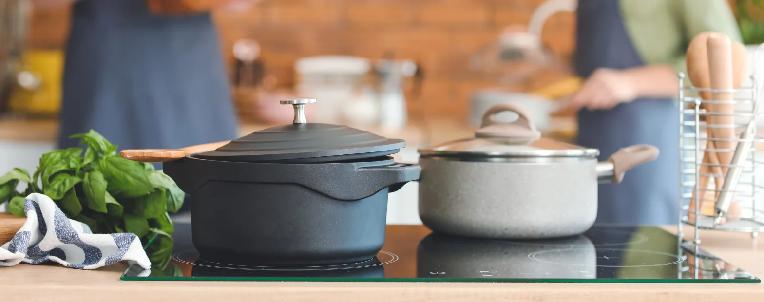 Pots sitting on an induction cooktop in a modern kitchen