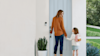 A mother and daughter using a ring doorbell