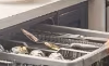 woman stacks LG QuadWash Dishwasher