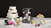 The breville bambino next to a cake and range of coffees