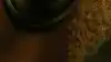 A woman standing on the side listening to her bose quiet comfort Ultra headphones