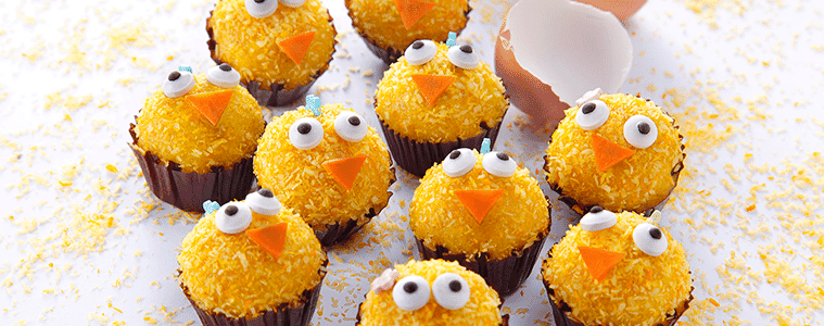 Carrot cake orange cupcakes with eyeball candy to resemble baby chicks on a white plate next to a broken eggshell Image courtesy of Bosch
