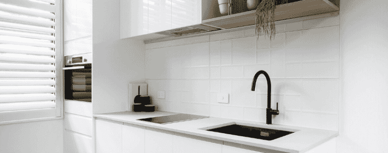 A white flat pack kitchen with black accents