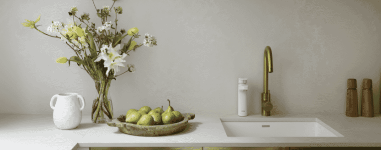 Sleek modern allwhite butlers pantry with inset sink brass gooseneck tap and overhead cupboards