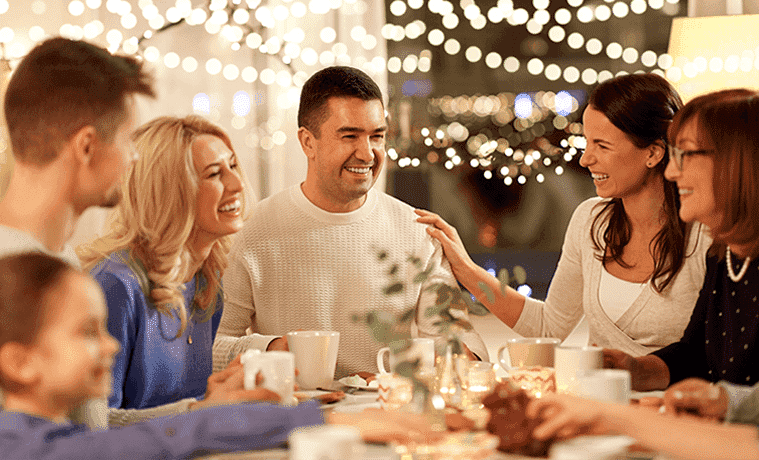 A large family all eat dinner together