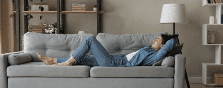 Side view woman enjoy day nap on comfy sofa