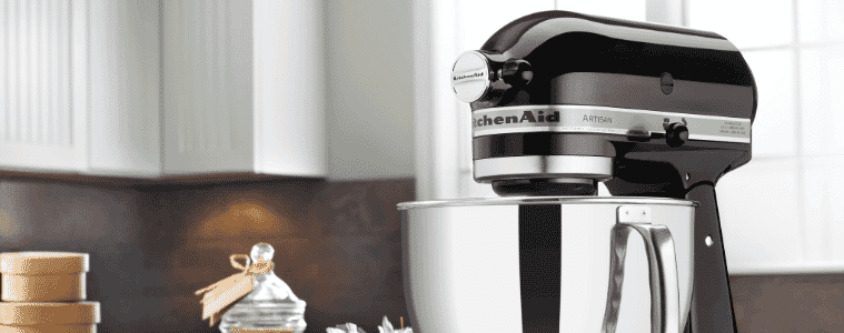 A black standmixer in a white kitchen