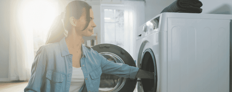 Lady loading her heat pump dryer