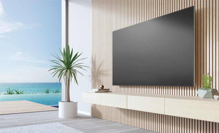 A large TV in a stylish modern living room by the beach