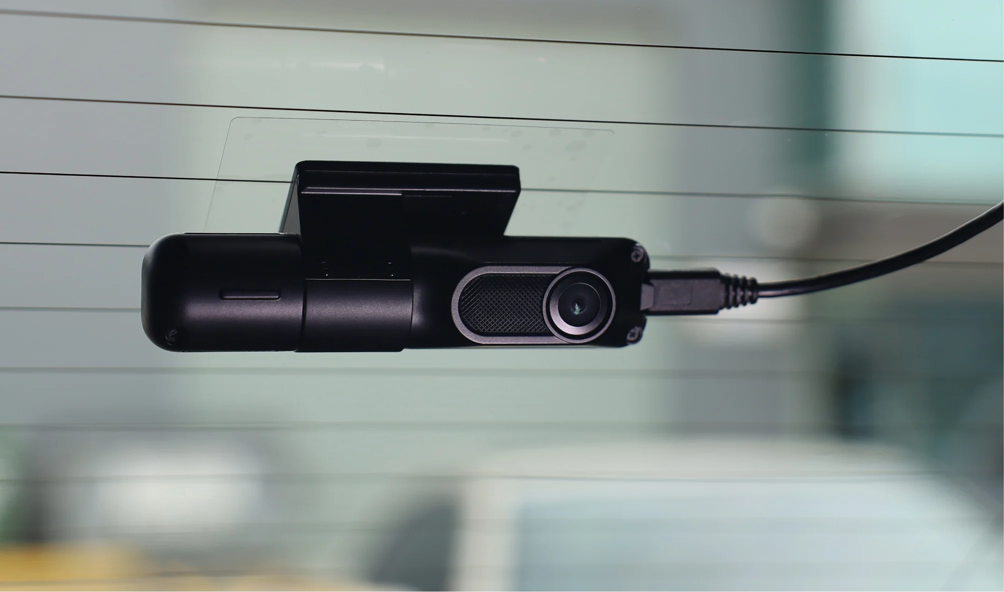 A Navman dash cam attached to the back windscreen of a car