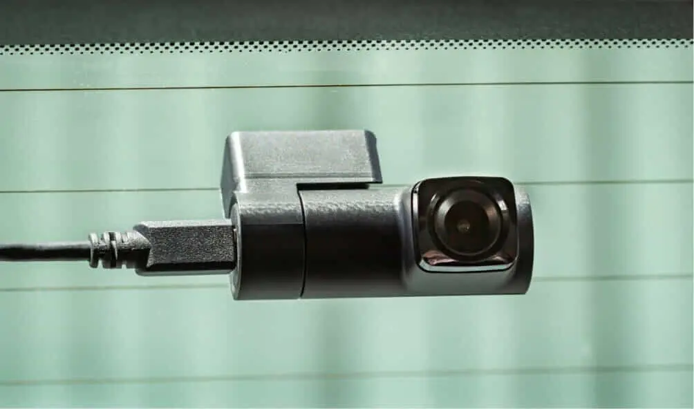 A Navman dash cam attached to the back windscreen of a car