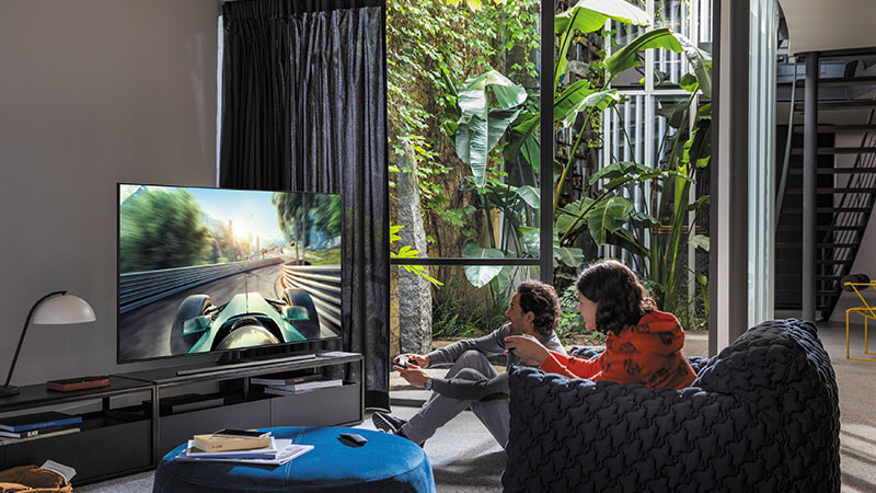 People having fun playing videos games on their new Samsung  TV