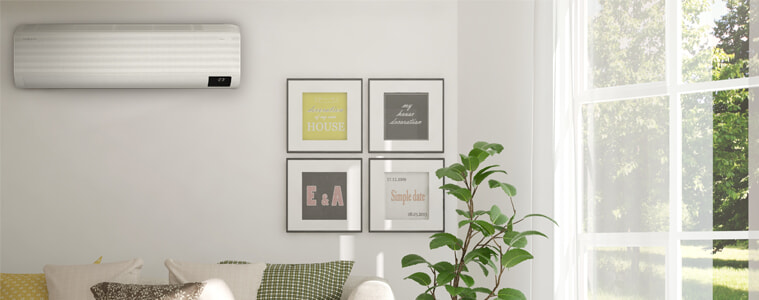 A Samsung Airise Windfree Split System Air Conditioner in a living room by a window