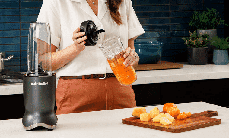 a woman making a juice using her Nutribullet blender 
