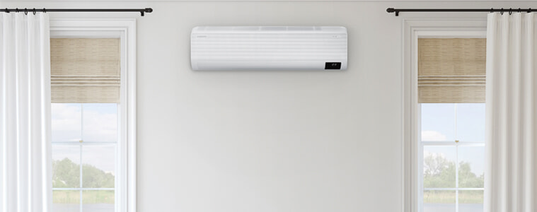 Samsung Airise WindFree Split System Air Conditioner in a living room positioned between two windows