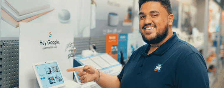 a good guys team member playing with a google home in store 