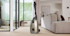 man cleans living room with Miele Duoflex vacuum