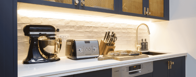 Butlers pantry with deep blue cabinetry integrated dishwasher and benchtop with toaster and Kitchenaid stand mixer