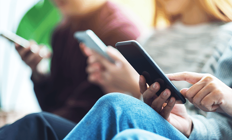 Teens using phones together 
