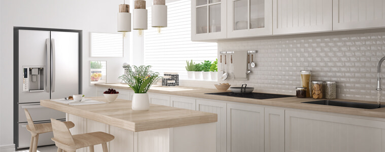 A chrome fridge in a white modern kitchen