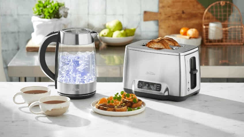 Sunbeam kettle and toaster on kitchen benchtop surrounded by cups of coffee and toast