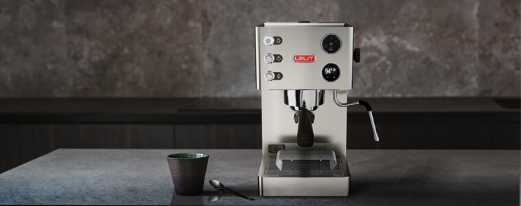 A Lelit Victoria coffee machine sits on a grey benchtop in a kitchen