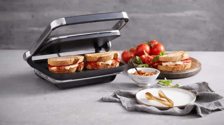 Sunbeam sandwich press with two toasted sandwiches inside