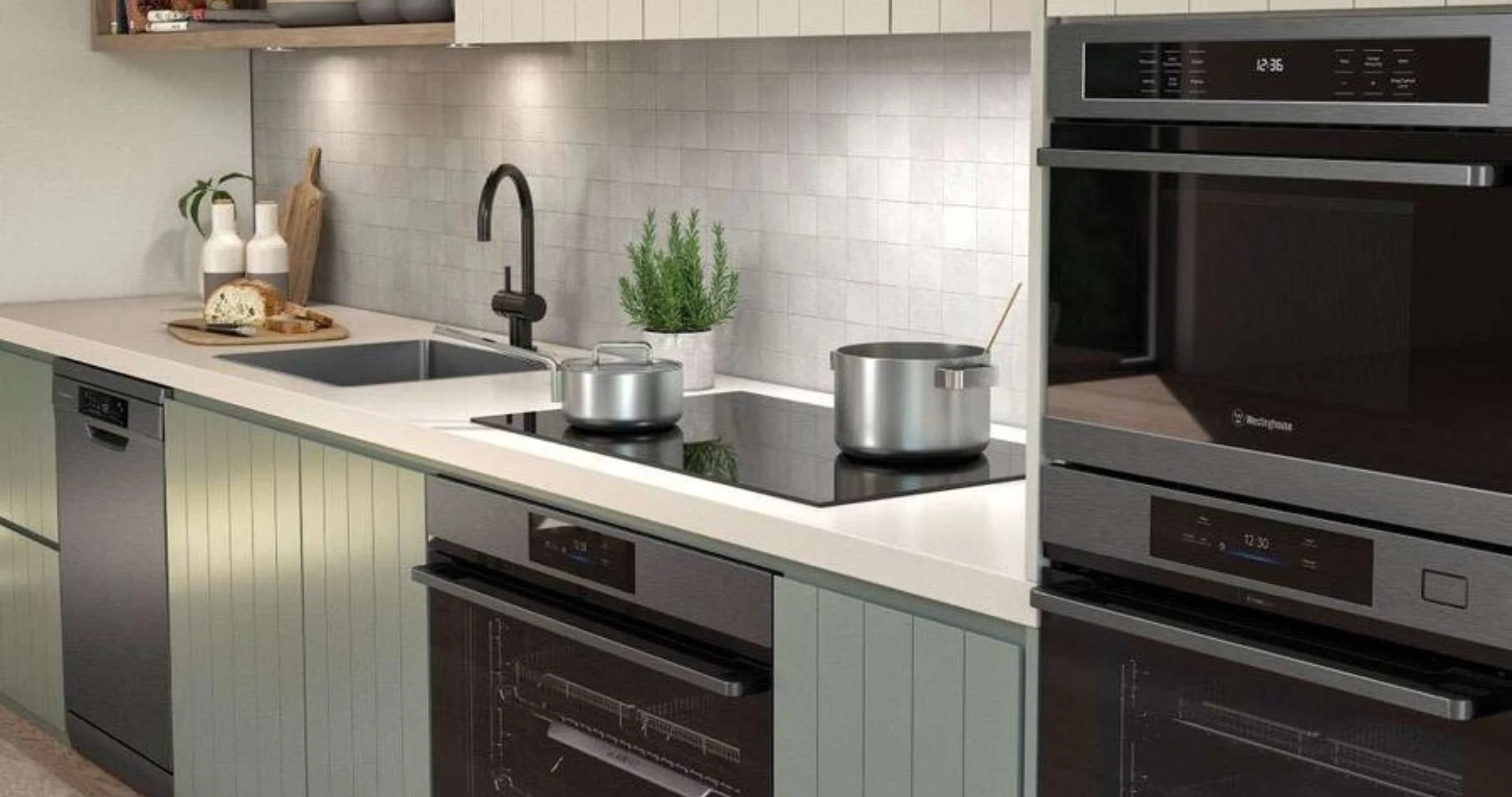 Image of a modern kitchen fitted with Westinghouse double ovens, induction cooktops and dishwasher.