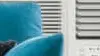 Air conditioning unit on windowsill in living room.