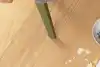 Mother uses Shark steam mop to clean child's spilt cereal.