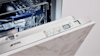 Close up of open built in smeg dishwasher.