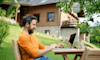 A man uses his laptop outside.