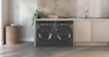 A Haier Washer and Dryer sitting next to each other in a modern laundry