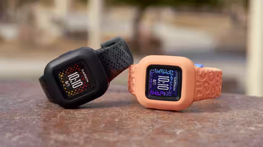 Close-up image of two Garmin Kid's Smart Watches side by side on an outdoor table