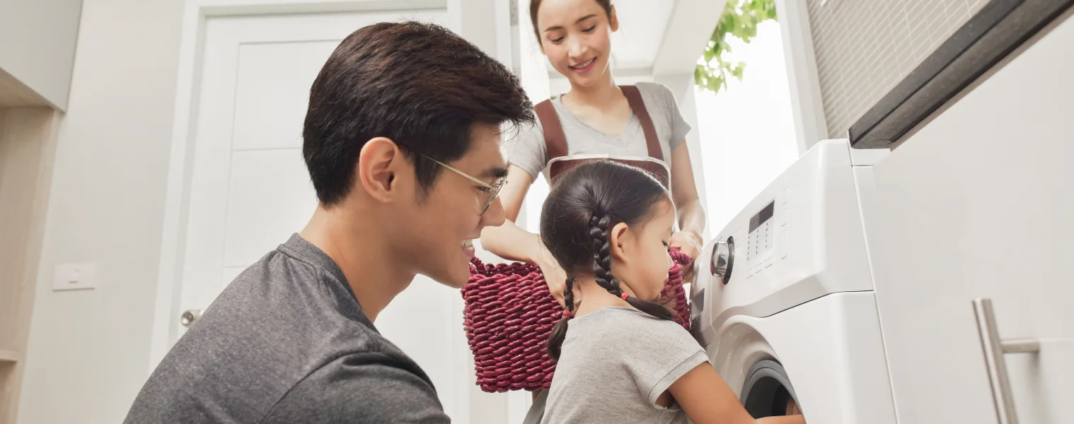 family loads a washing machine