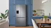 Stylish Samsung fridge with big freezer in blue kitchen.