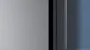 Stylish Samsung fridge with big freezer in blue kitchen.