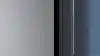 Stylish Samsung fridge with big freezer in blue kitchen.