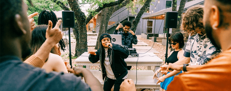 A man performs at a gathering using the Bose S1 Pro Wireless PA System