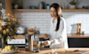 Woman getting hot tea from her water purifier 