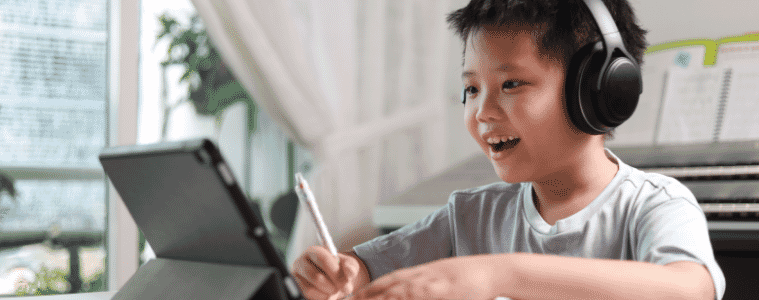 Child using a 2in1 tablet to study