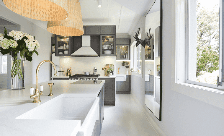 A classic white and grey country kitchen with brushed gold accents