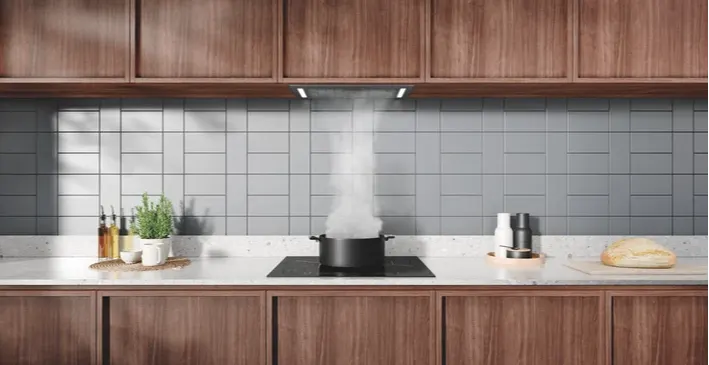 Electrolux rangehood extracting steam above a cooktop in a tiled kitchen