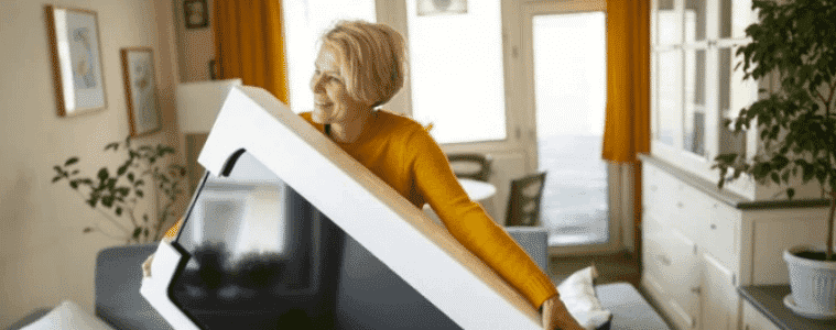 Happy woman opens her new Black Friday Sale purchase in her home