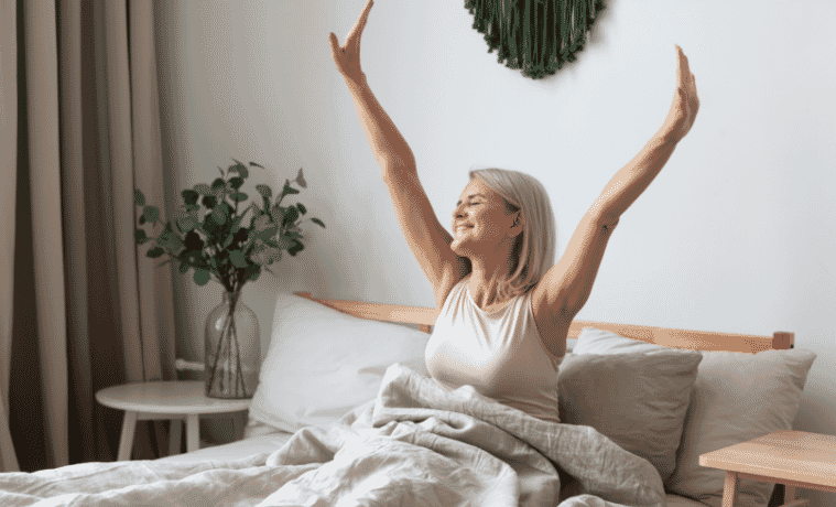 A woman yawning in bed after a restful night sleep 