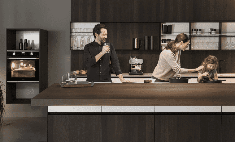 A family cooking in their kitchen using DeLonghi kitchen products 
