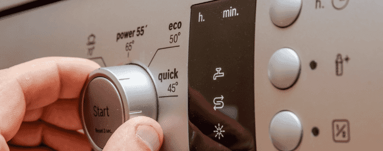 A man selects the eco wash setting on the control panel of his dishwasher